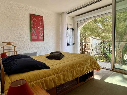 une chambre avec un lit et une grande fenêtre dans l'établissement Appartement cosy 3 pièces avec piscine, 6 couchages, proche mer à Argelès-sur-Mer - FR-1-225-669, à Argelès-sur-Mer