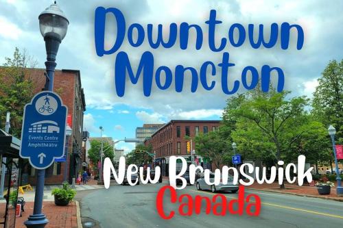 a street sign in a town with a street light at Dominion Place Studio in Moncton