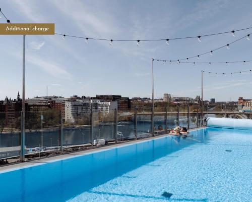 a swimming pool on the roof of a building at Clarion Hotel Sign in Stockholm