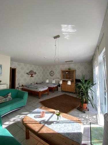 a living room with a couch and a table at Ferienwohnung Erlenhof in Engelskirchen