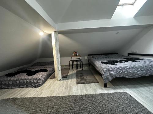 a bedroom with two beds and a table in it at Vila Ana 2 Untold in Cluj-Napoca