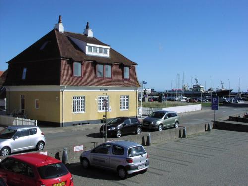 a group of cars parked in front of a building at Skagen Apartment in Skagen