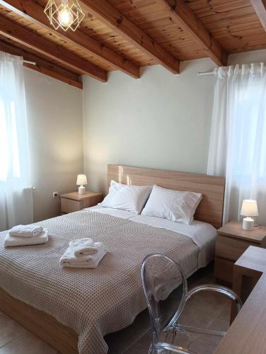 a bedroom with a bed with two towels on it at La Casa Di Kokkines in Plytra