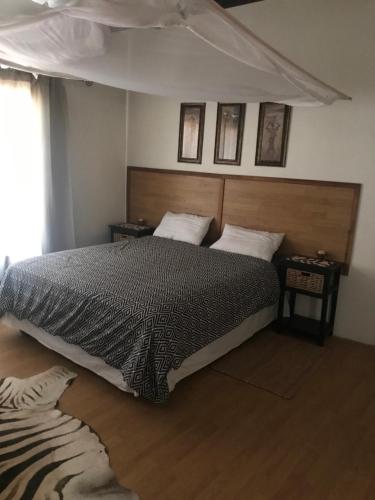 ein Schlafzimmer mit einem großen Bett und einem Fenster in der Unterkunft Big Cats Namibia Self Catering Farm Guesthouse in Outjo