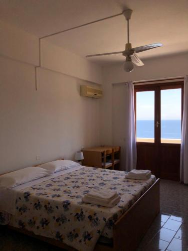 a bedroom with a bed with a view of the ocean at Hotel Ariston in Ustica