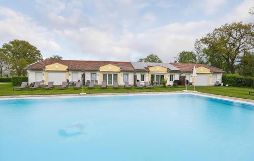 a large swimming pool in front of a house at 2 Bedroom Nice Home In Rotthalmünster in Rotthalmünster