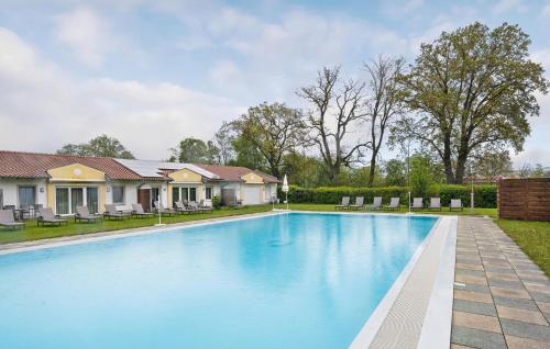 a swimming pool in the backyard of a home with a house at 2 Bedroom Nice Home In Rotthalmünster in Rotthalmünster