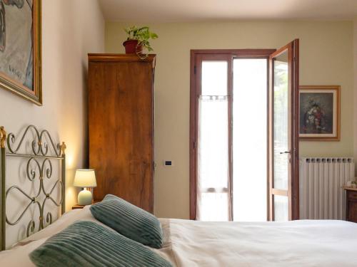 a bedroom with a bed and a sliding glass door at B&B Casa Decimo in Greve in Chianti