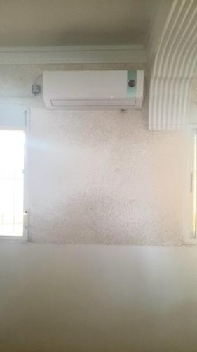 a room with a white air conditioner on the wall at Wardania in El Kabar