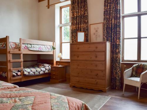 a bedroom with a bunk bed and a dresser at The Coach House At Waterperry Gardens in Waterperry