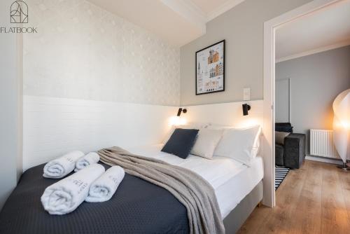 a bedroom with a bed with towels on it at Flatbook - City Center Apartments Angielska Grobla in Gdańsk