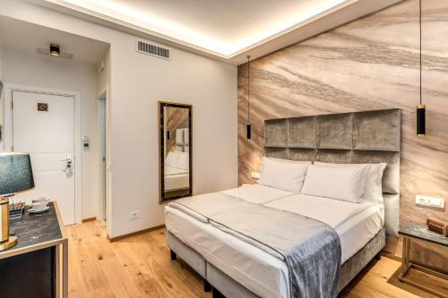 a bedroom with a large bed and a television at Goldoni 47 in Rome