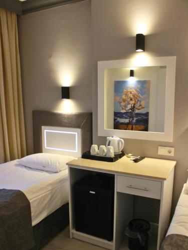 a hotel room with a bed and a desk in it at Hotel Peninsula in Istanbul