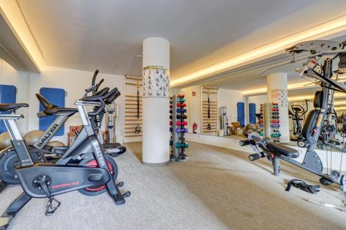 a gym with three exercise bikes in a room at Hotel Illa d'Or & Club Apts 4* Sup in Port de Pollensa