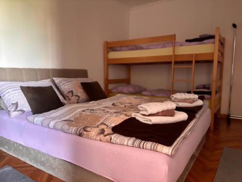 a bedroom with a bed with two bunk beds at Villa Mostar - Resort Rozic in Mostar