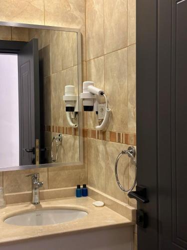 a bathroom with a sink and a mirror at Hotel Peninsula in Istanbul