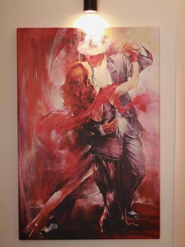 a painting of two people dancing on a wall at Hotel Peninsula in Istanbul