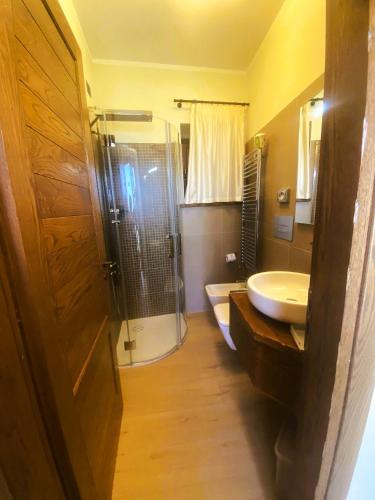 a bathroom with a shower and a sink and a toilet at Il Borgo Ospitale - Albergo Diffuso in Rotonda