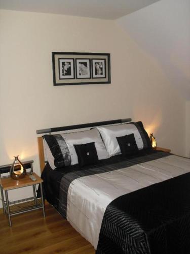 a bedroom with a bed with black and white pillows at On the Rocks B&B in Greencastle