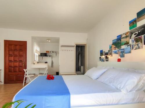 a large white bed in a room with a kitchen at Grandma’s House - Το σπίτι της Γιαγιάς in Skiathos Town