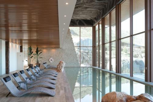a room with chairs and a glass floor at Encosta de Louredo by Pousadela Village in Vieira do Minho