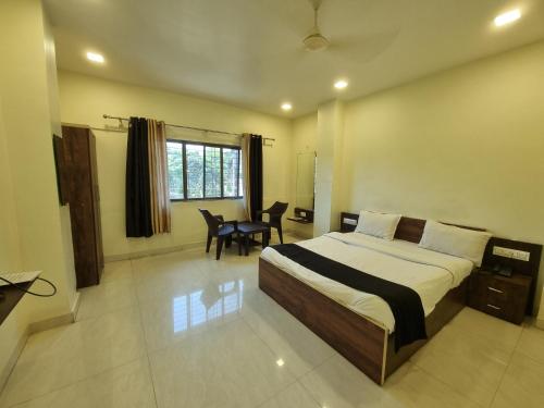 a bedroom with a bed and a table in it at The Living Space in Lonavala