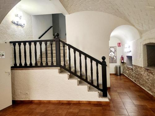 a staircase in a building with a stair case at Hotel Castell Blanc in Empuriabrava