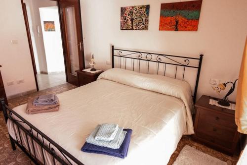 a bedroom with a bed with a blue towel on it at il Ciclope di Annalisa in Alatri