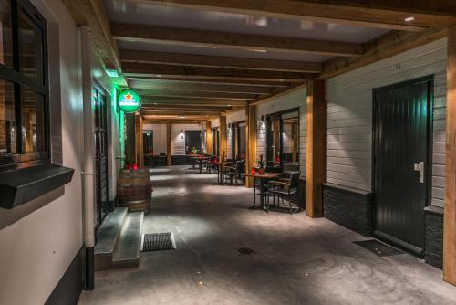 a corridor of a building with tables and chairs at Hotel-Restaurant Unicum Elzenhagen in Poeldijk