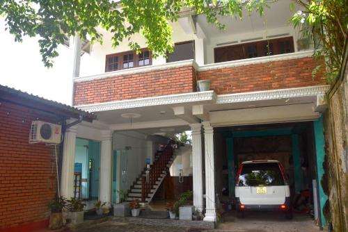 a white van parked inside of a building at Rathna Gems Halt in Ratnapura