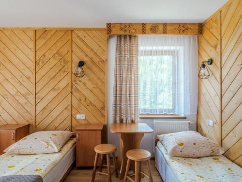 Un pat sau paturi într-o cameră la Ośrodek Wczasowy Pasternik