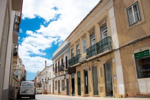 a van parked on a street next to buildings at Blife Alicya private rooms in Faro