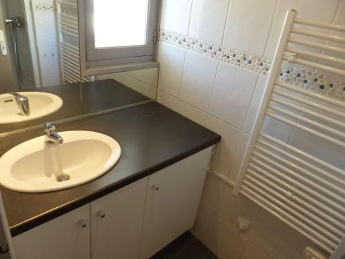 une salle de bain avec deux lavabos et un miroir dans l'établissement Appartement T2 au 2e étage sans ascenseur: Terrasse, TV, lave-vaisselle, wifi en option - FR-1-308-197, au Lavandou