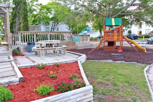 a playground with a picnic table and a slide at 2BR/2BA Condo at Arcadian Dunes Building 10-238 in Myrtle Beach