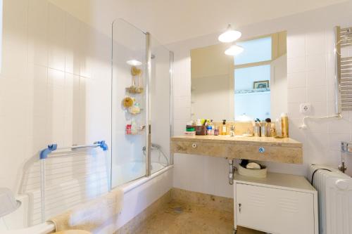 a bathroom with a shower and a sink at Casa Cima Rio in Alcácer do Sal
