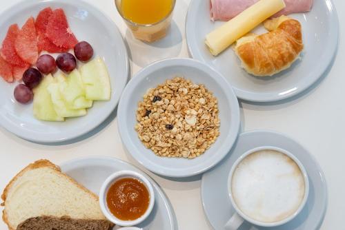 a white table topped with plates of breakfast foods at Vain Boutique Hotel in Buenos Aires