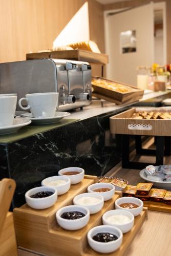 a buffet line with different types of food in bowls at Vain Boutique Hotel in Buenos Aires