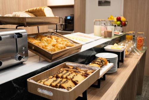 a buffet with bread and pastries on a counter at Vain Boutique Hotel in Buenos Aires