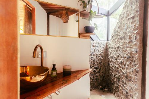 a bathroom with a wooden sink and a mirror at Almara House in El Valle