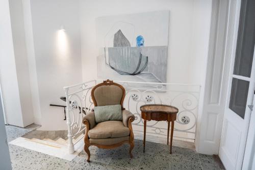 a chair and a table in a room at Vain Boutique Hotel in Buenos Aires