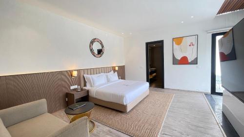 a hotel room with a bed and a couch at Velmore Kasauli Operated by Royal Orchid Hotel Ltd. in Kasauli