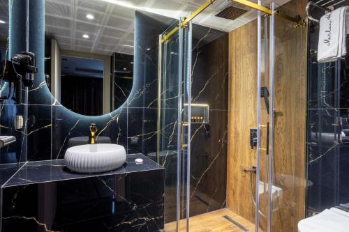 a bathroom with a sink and a shower at Marlon Hotel in Istanbul