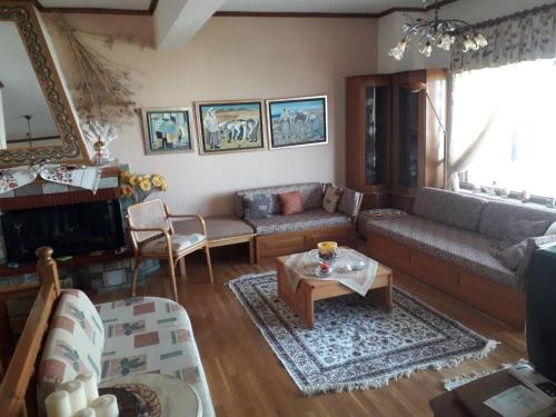 a living room with a couch and a table at Poly's House in Kavála