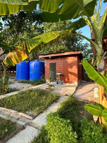 a small house with blue barrels in front of it at Maloop Cafe Bungalow in Koh Rong Island