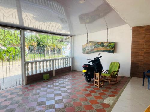 a scooter parked in a room with a window at Rutymar crab in Necoclí