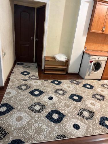 eine Küche mit einem Teppich auf dem Boden und einem Herd in der Unterkunft Юнусабад 13 корзинка 