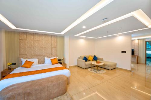 a large bedroom with a large bed and a couch at Serene Horizon in Thekkady