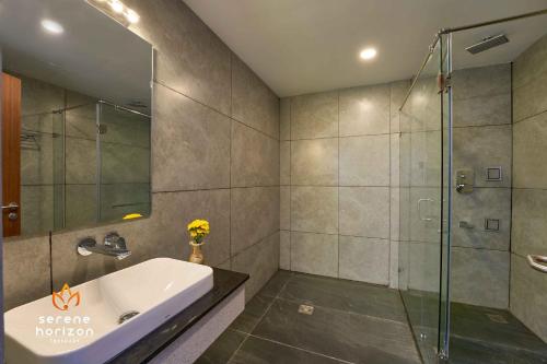 a bathroom with a sink and a shower at Serene Horizon in Thekkady