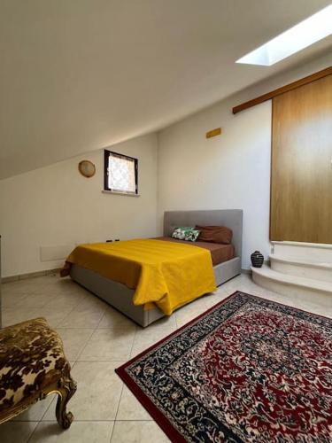 a bedroom with a bed with a yellow blanket at Sweet home Rosarno in Rosarno