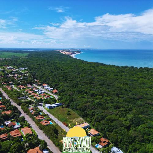 an aerial view of a resort with a beach and the ocean at 3QUARTOS PIPA4YOU in Pipa